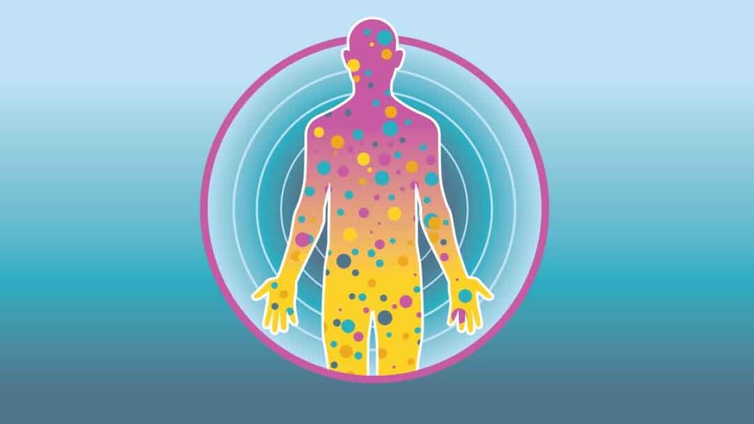 Abstract illustration of a human silhouette filled with colorful dots, symbolizing the complexity of mast cell disease, surrounded by a pink circle and concentric blue rings on a gradient blue background. The colors transition from pink to yellow from head to feet.