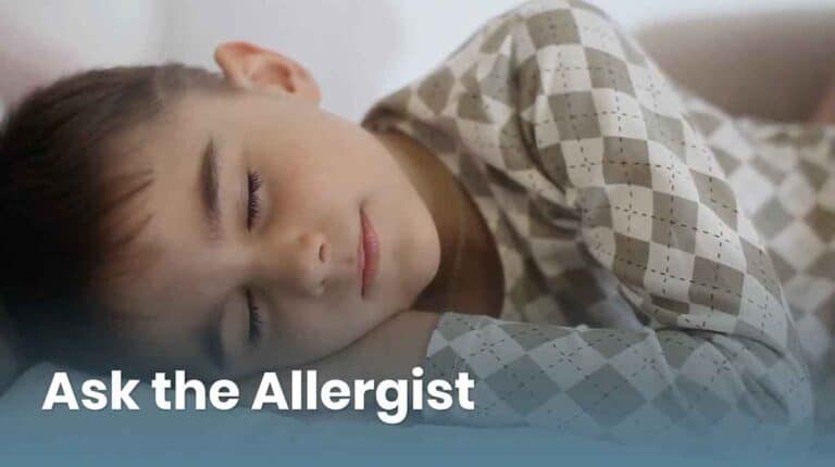 A child with short hair sleeps peacefully, wearing a checkered pajama top. The image has the text "Ask the Allergist" overlaid in the bottom left corner.