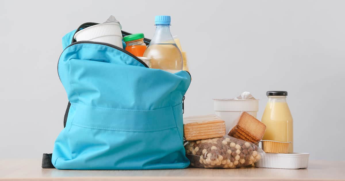 What Can You Do If You Can’t Afford Allergen-Free Foods? 2 blue backpack filled and surrounded with food