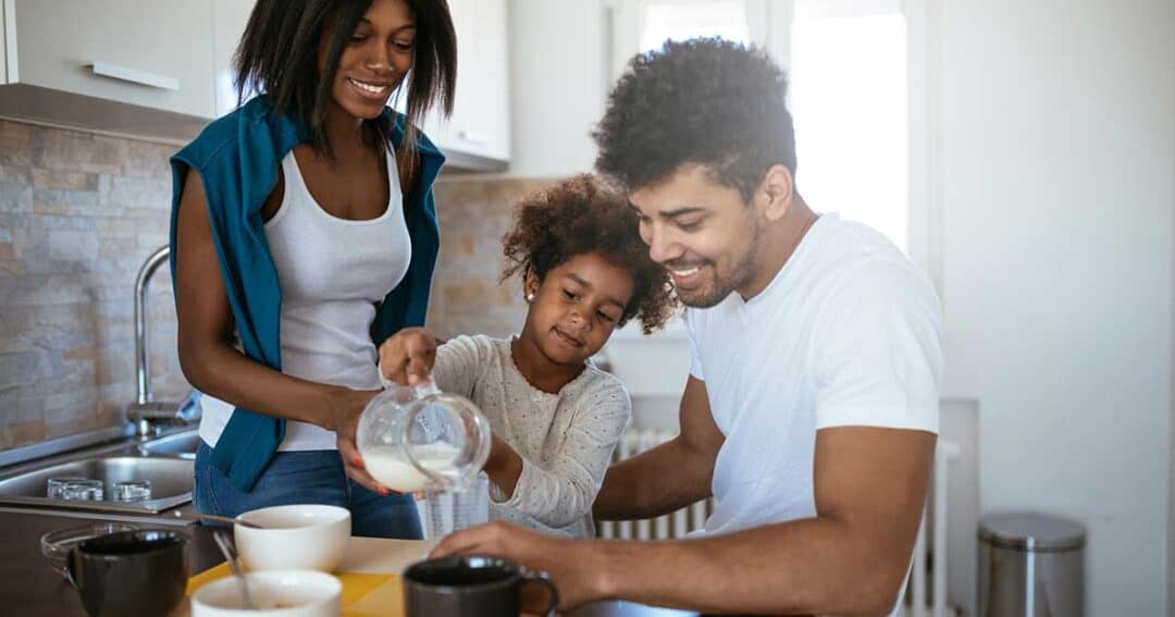 Family preparing breakfast together with allergen friendly foods.