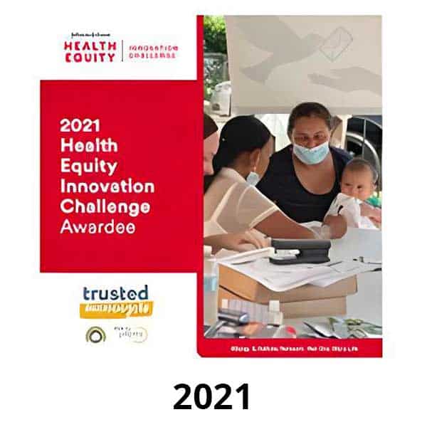 A poster titled "2021 Health Equity Innovation Challenge Awardee" features a group of people, including a person holding a baby. The background shows a table with documents and a laptop. Text at the bottom reads "trusted.