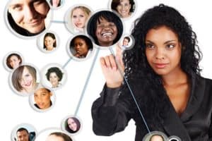A woman interacts with a network of floating, connected profile images of diverse people on a white background. She is touching one of the images, suggesting a focus on social or professional networking.