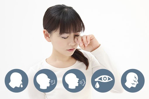 A person with long dark hair and a white top rubs their eye, appearing uncomfortable. Below are icons of symptoms: runny nose, cough, sneezing, teary eyes, and headache, indicating possible allergies or illness.