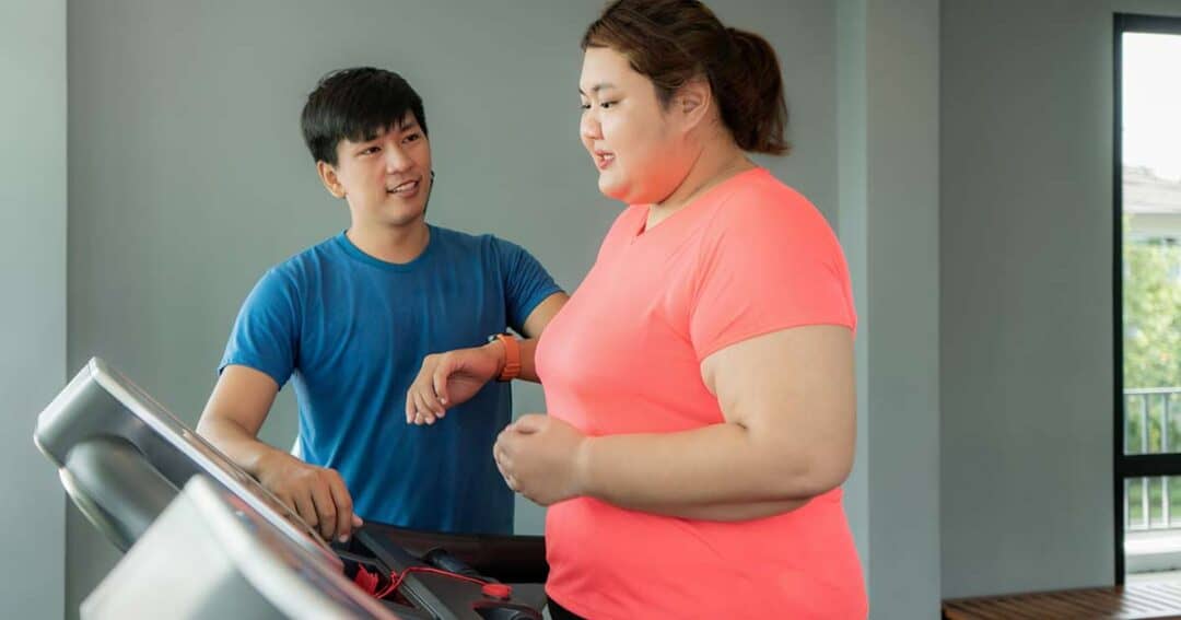 Alternative and Natural Asthma Treatments 3 Woman working out on treadmill as her trainer looks on.