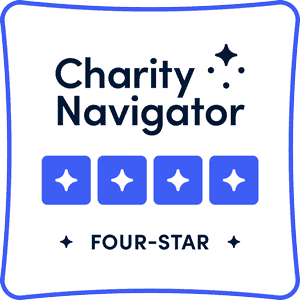 Logo of Charity Navigator with the text "Four-Star" and four blue stars below it, enclosed in a blue-bordered square.